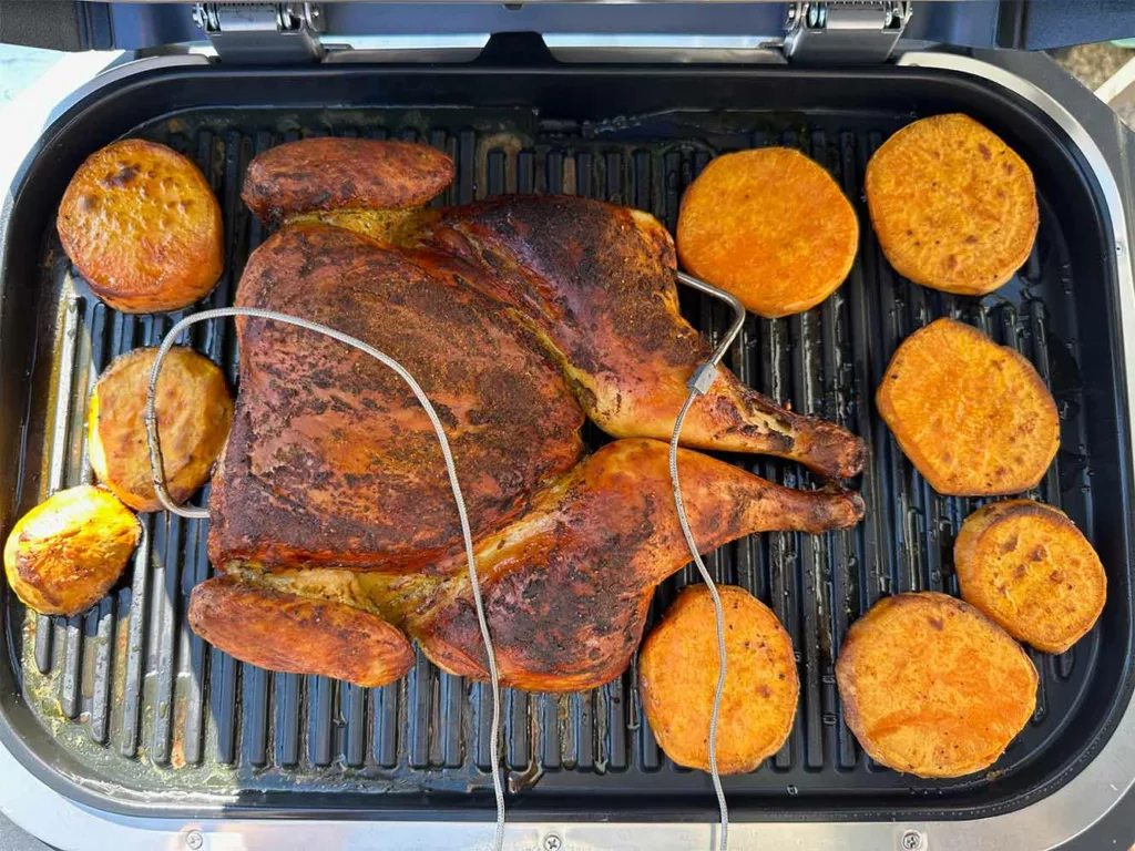 https://www.sizzleandsear.com/wp-content/uploads/2023/07/spatchcocked-whole-chicken-plus-side-on-ninja-woodfire-pro-connect-xl-1024x768.webp